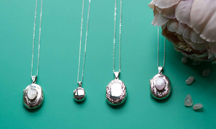 silver oval locket collection on a blue background