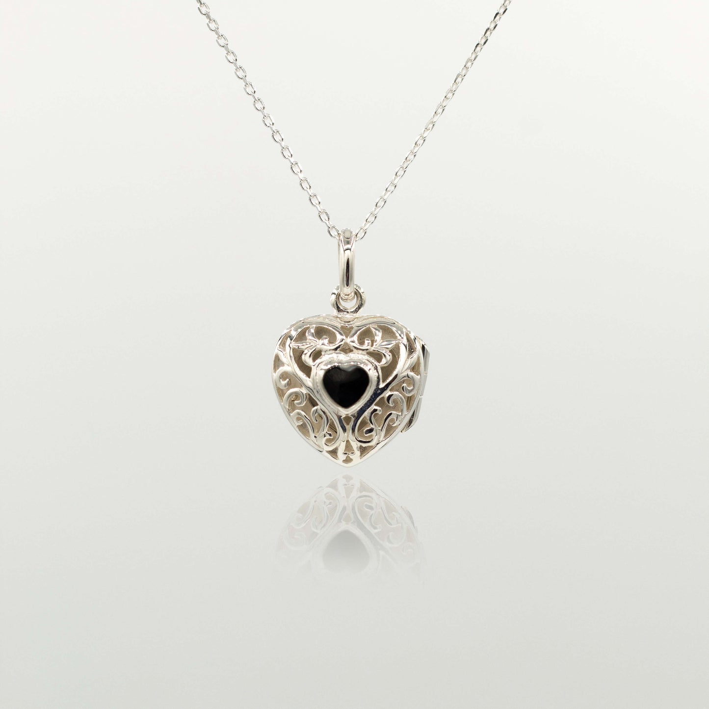 Locket necklace on a silver chain against white background