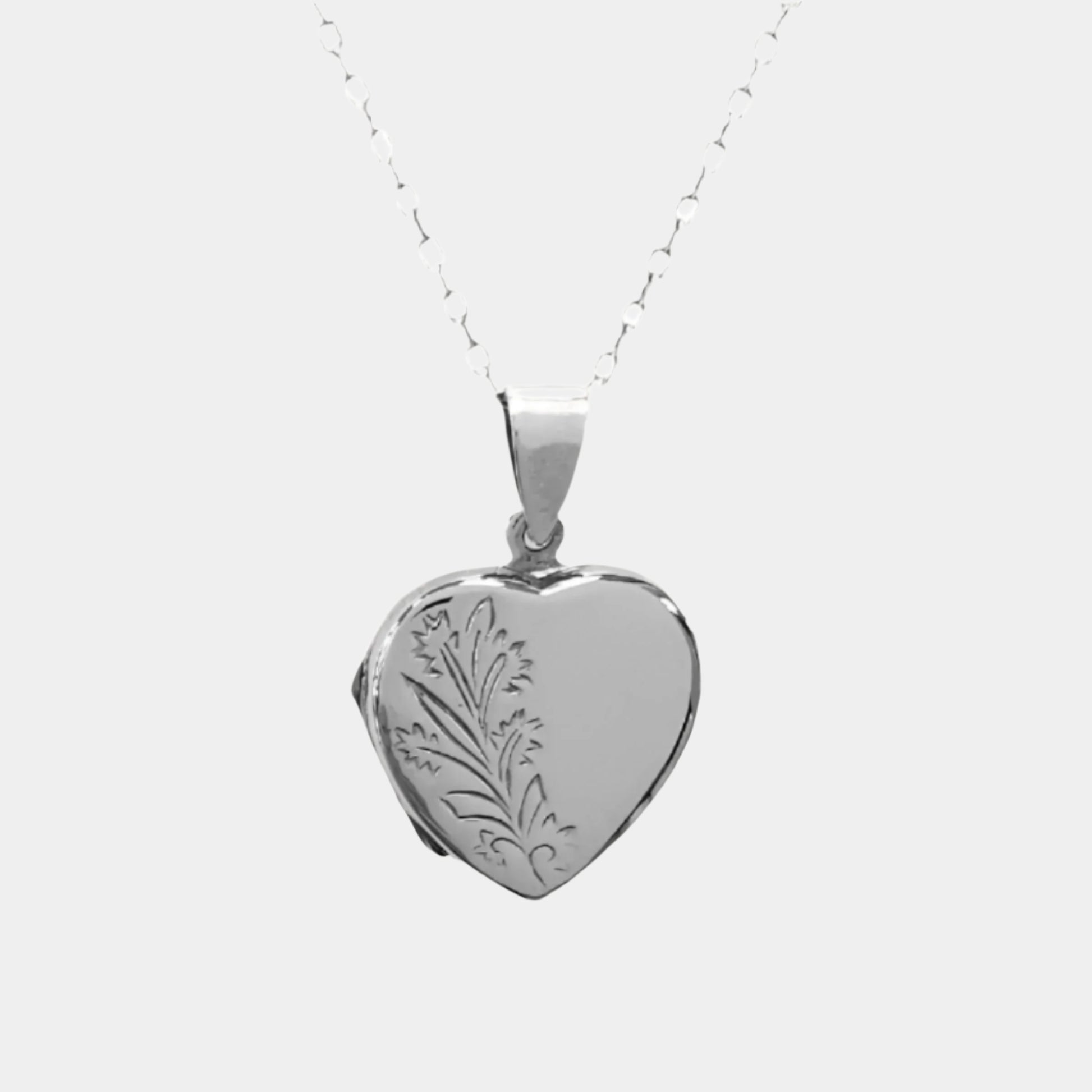 Heart shaped double photo locket in sterling silver on a white background