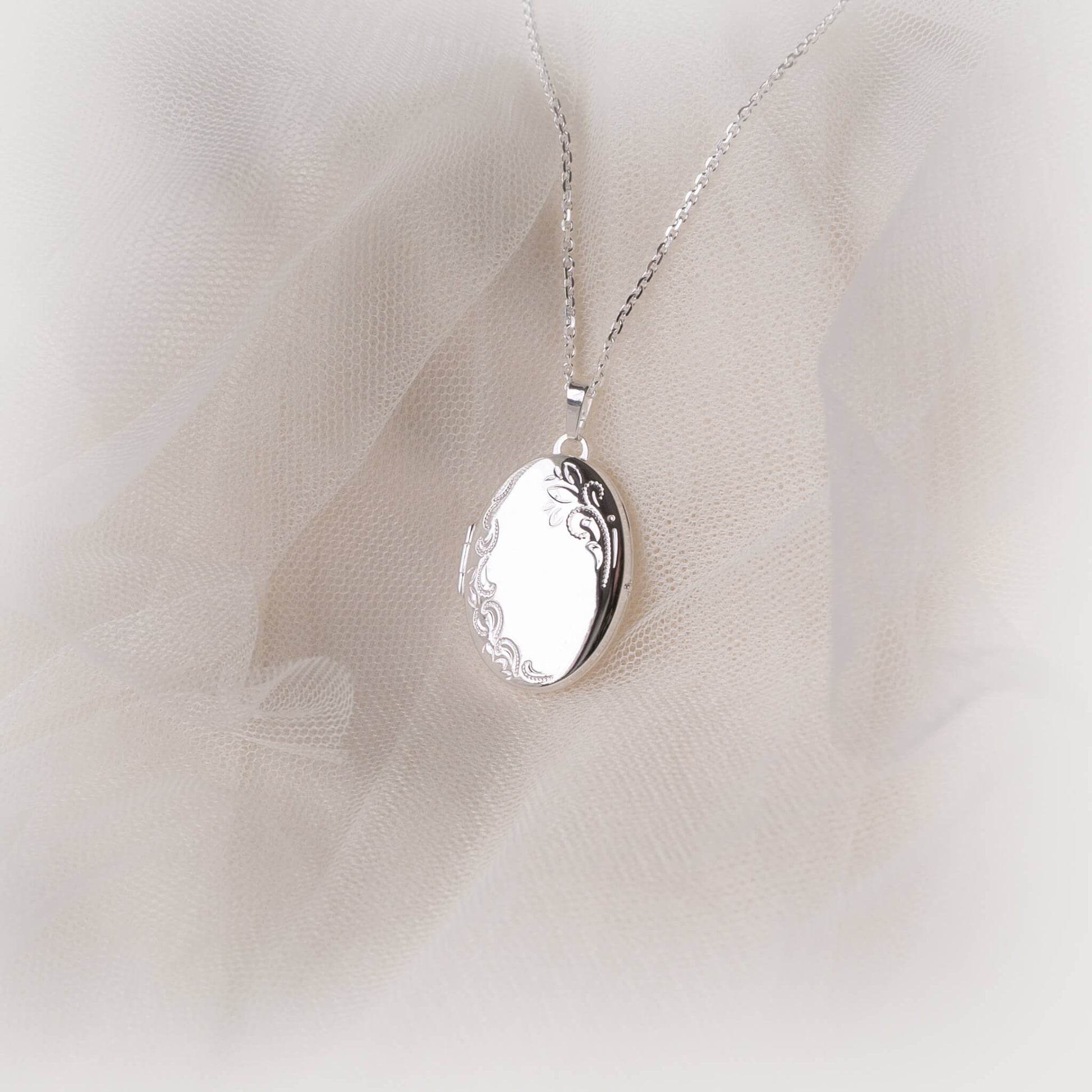 sterling silver locket on a light pink background
