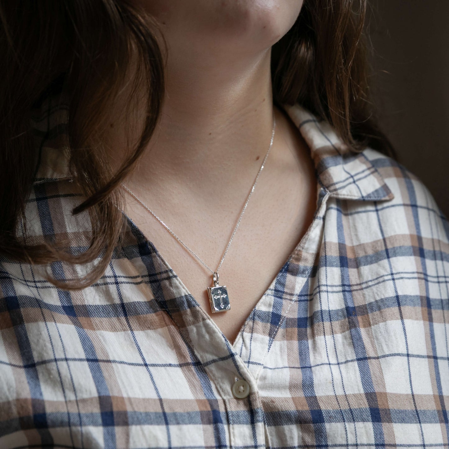 Model wearing small prayerbook locket