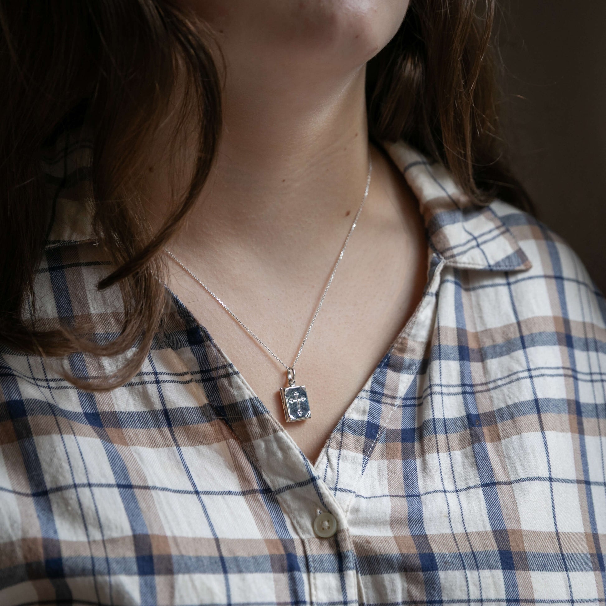 Model wearing small prayerbook locket