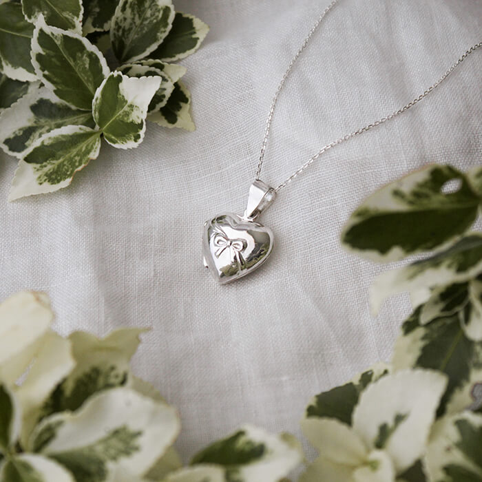 photo locket with bow on white background