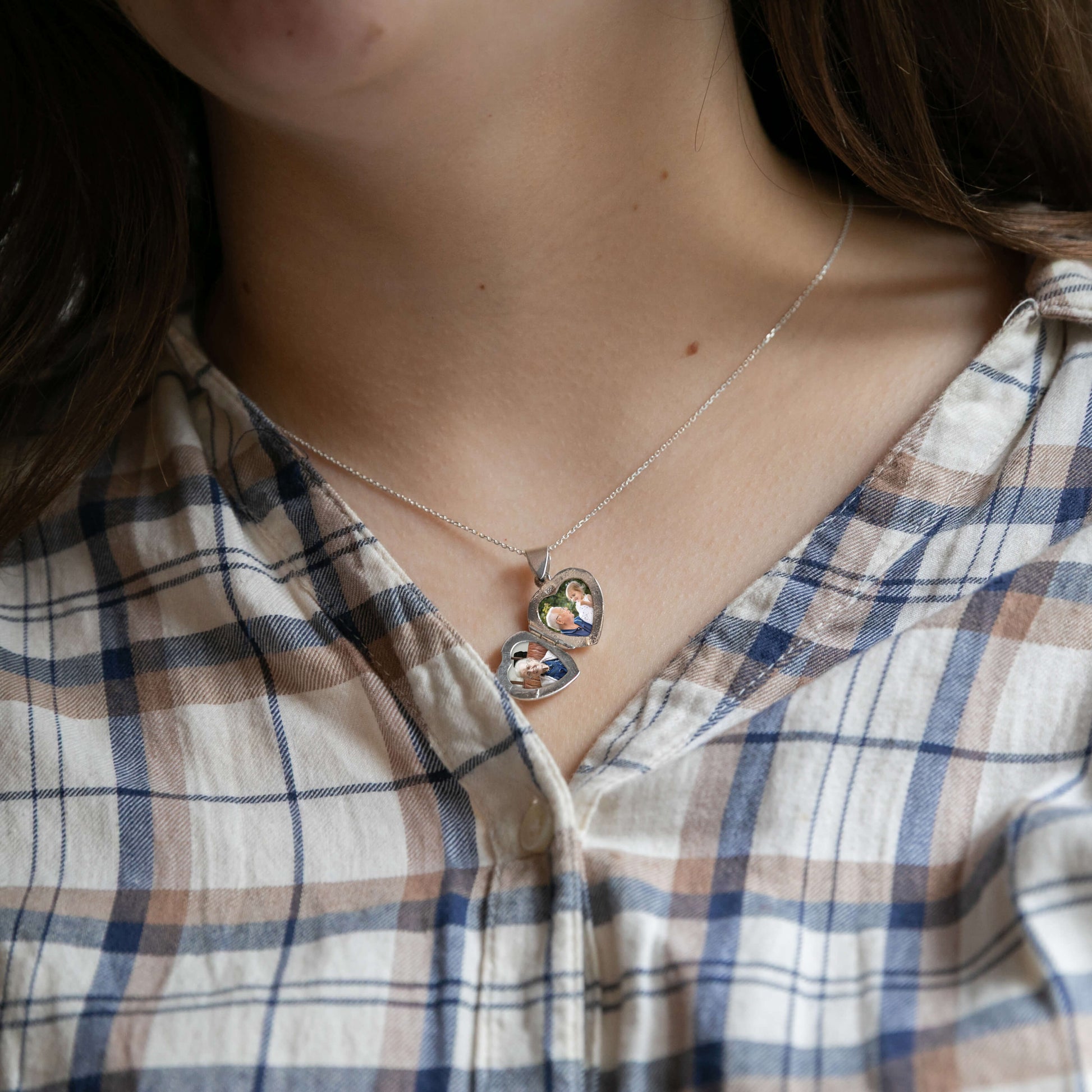 Model wearing open heart-shaped photo locket
