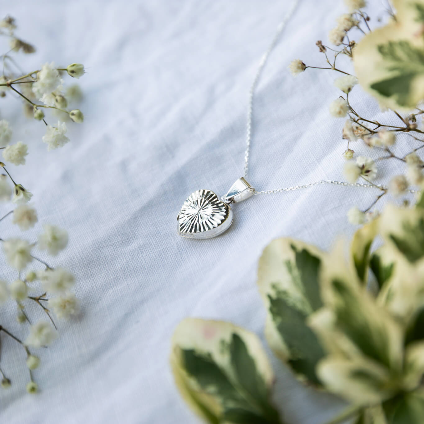 heart shaped photo locket in Sterling silver on a white background