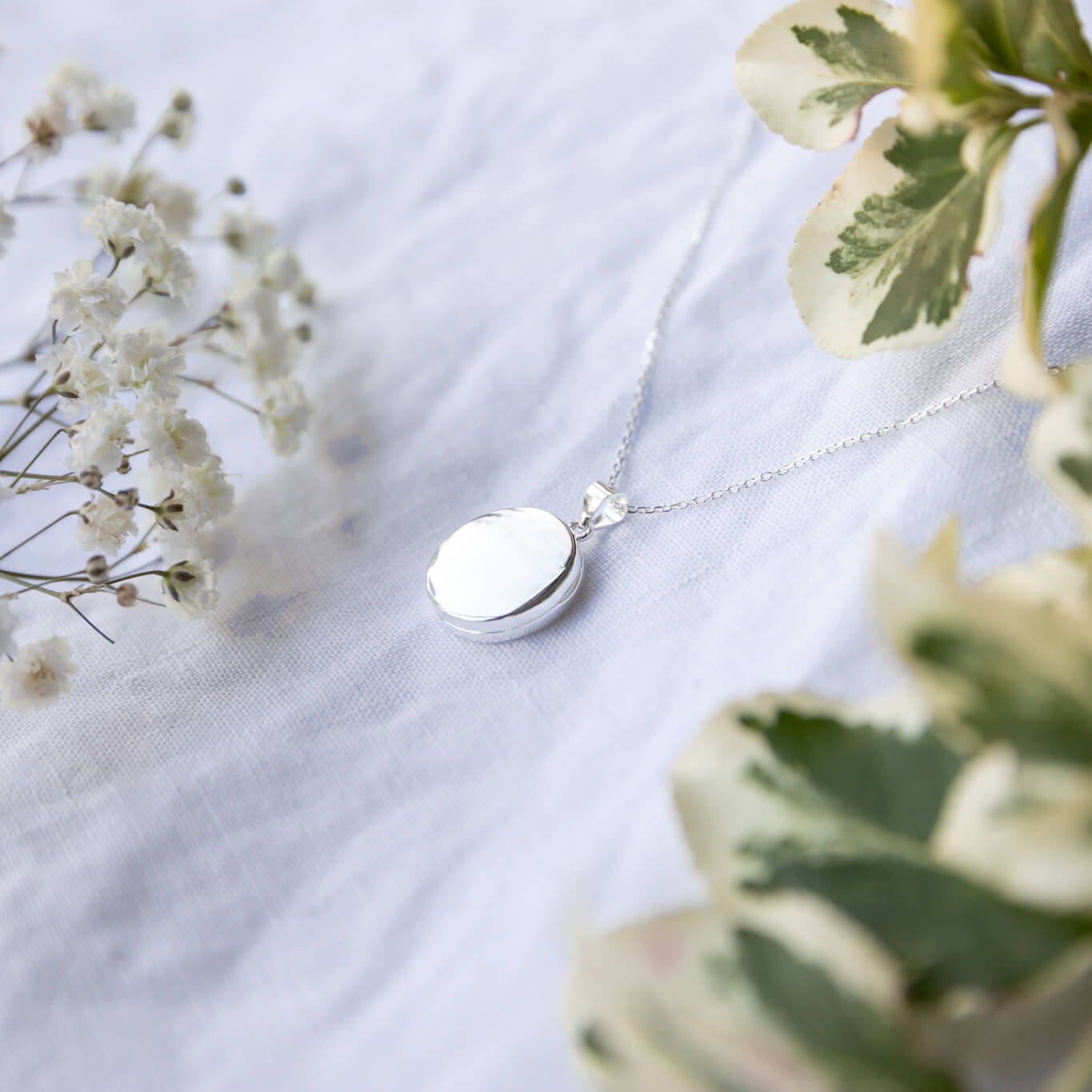 round silver locket on a white background