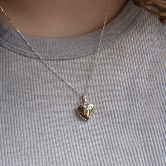 Model wearing heart locket with cubic zirconia