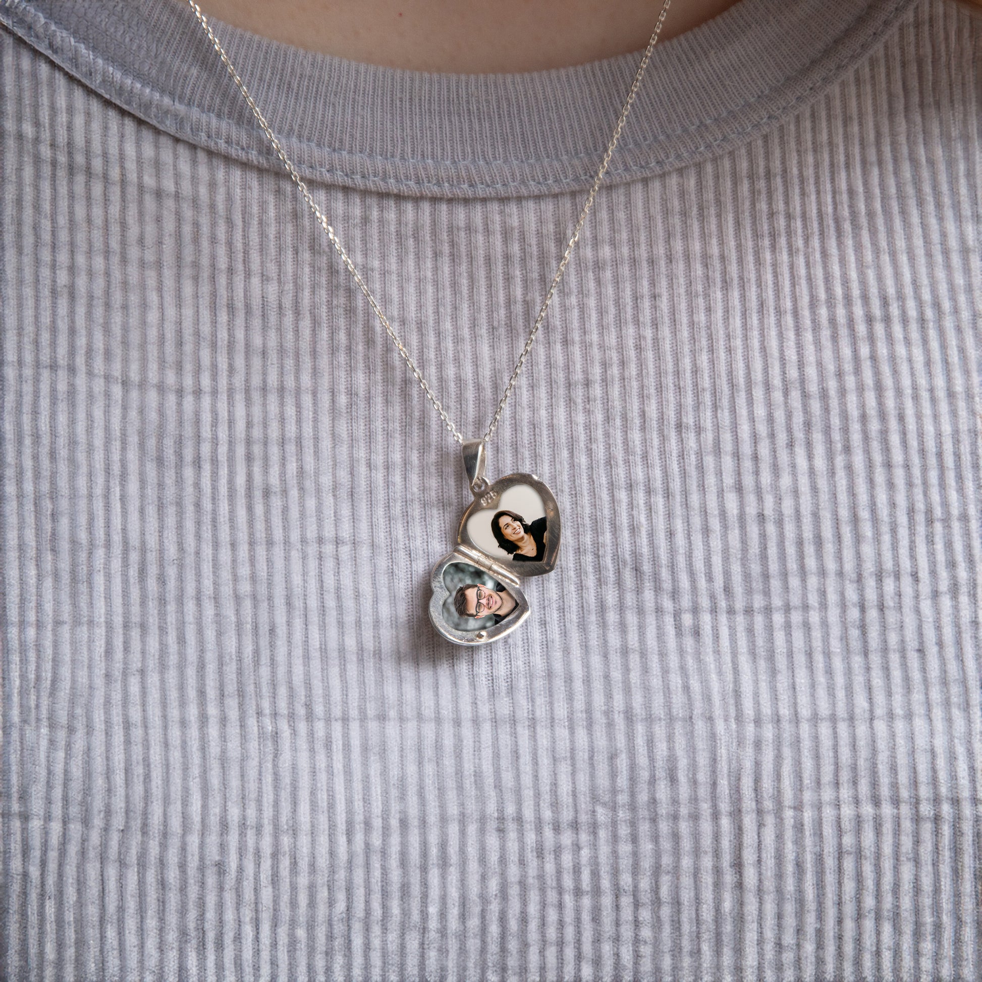 Model in grey wearing heart locket with cubic zirconia
