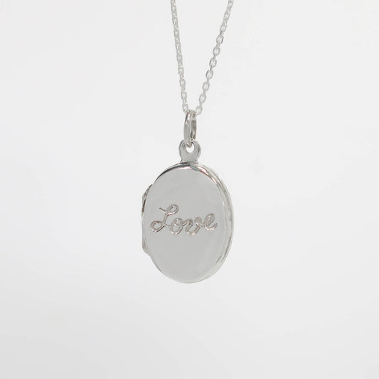 Silver locket necklace with 'Love' engraving on a white background
