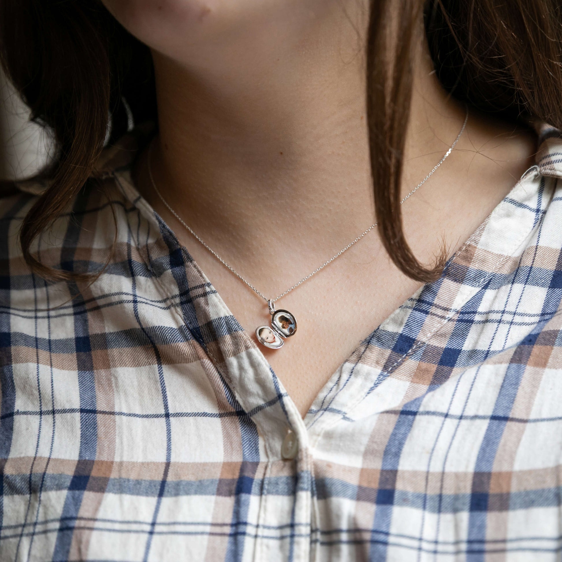 Small oval locket on model showing photos inside