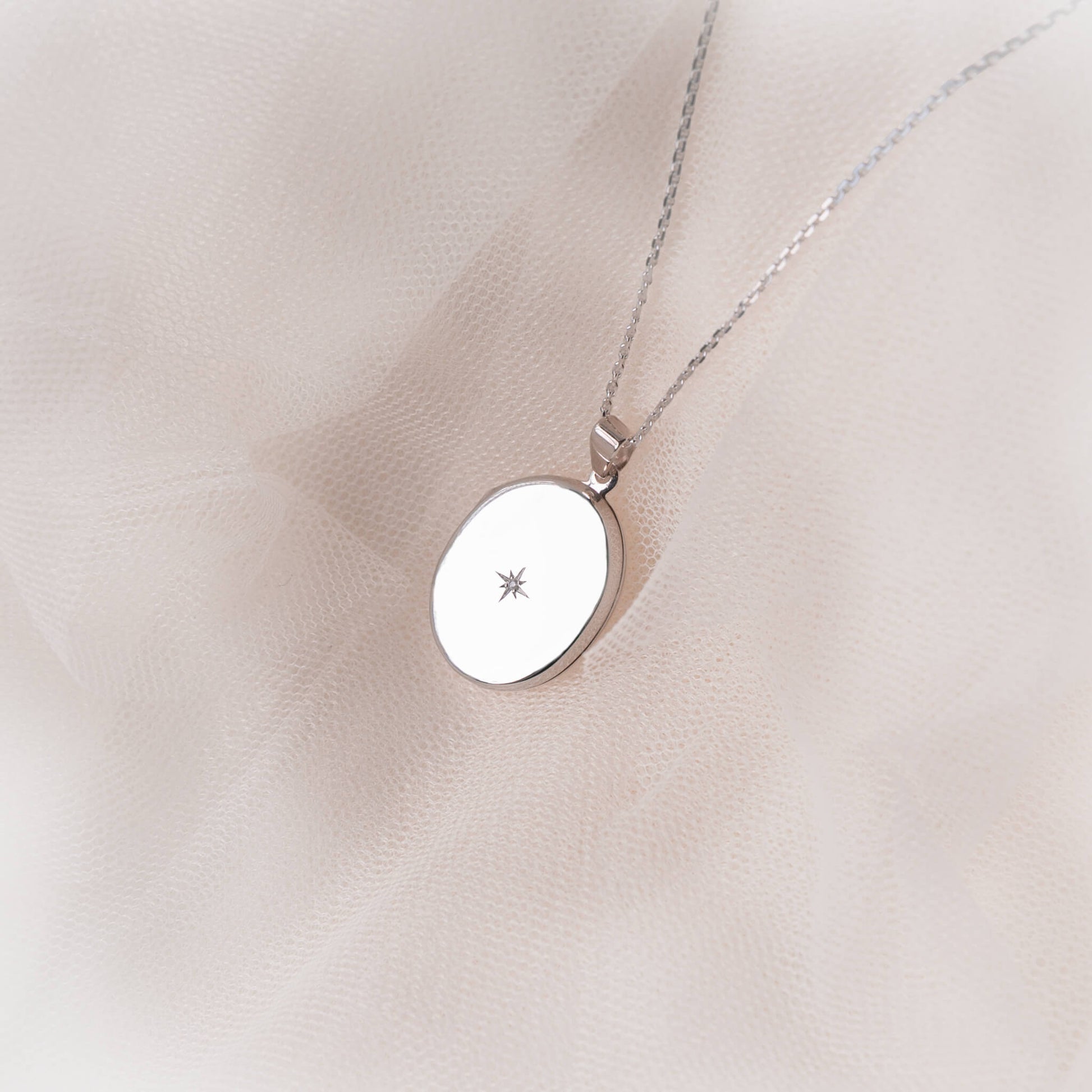 large silver locket with diamond