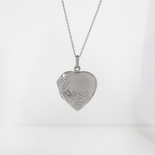 Silver heart-shaped pendant on a chain against a white background