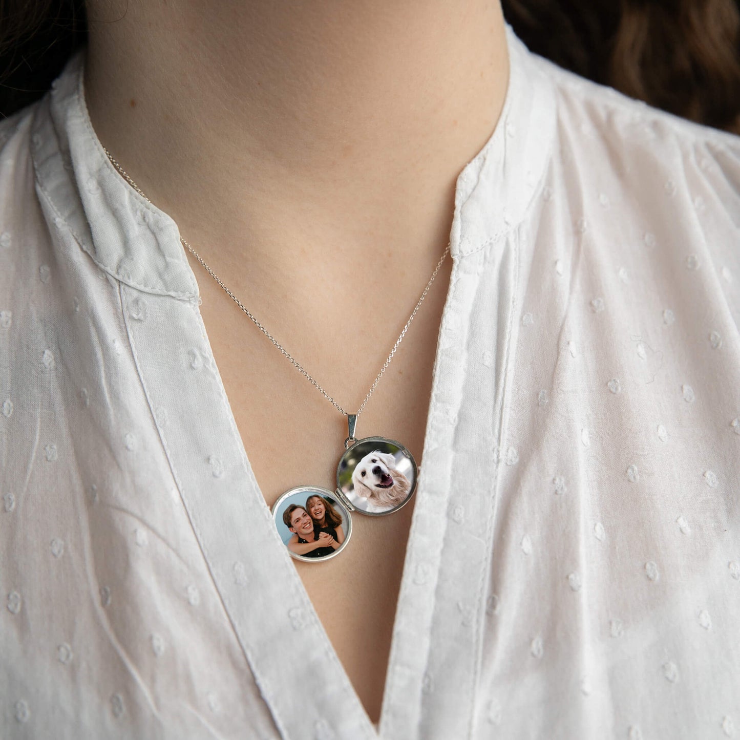 model wearing round photo locket open showing photos inside