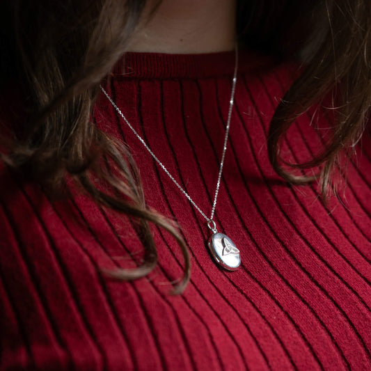 model wearing eltic design locket