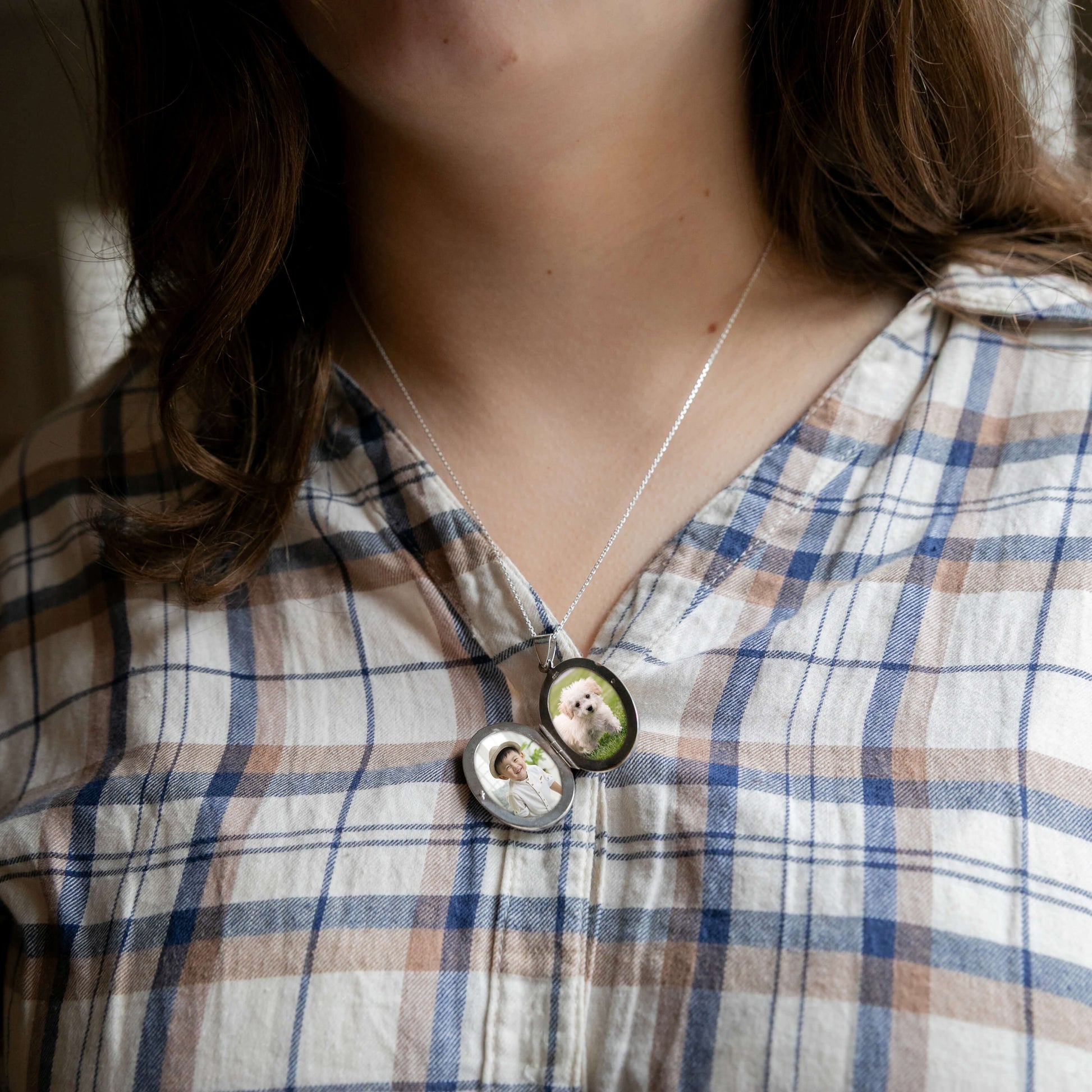 model wearing oval locket open showing photos