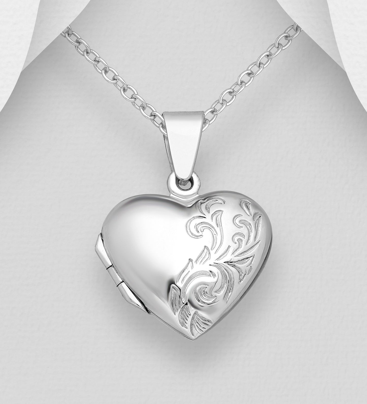 heart shaped photo locket with engraving on a white background